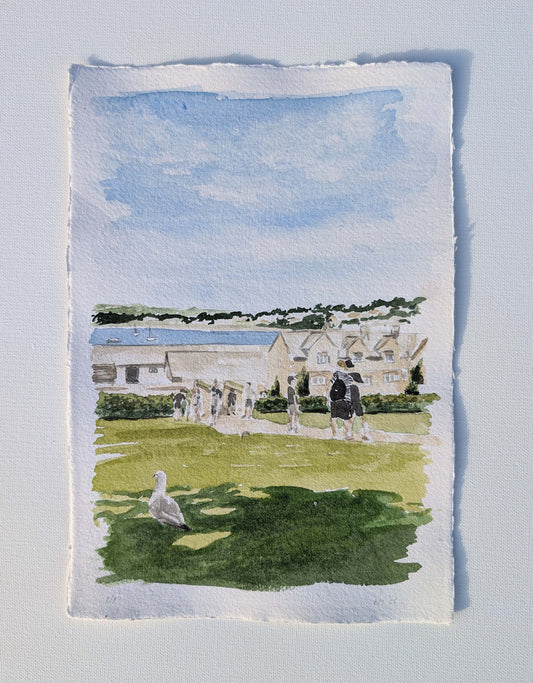 Watercolour of a Cornish scene with white cottages and figures on a green, by Daniela Militaru