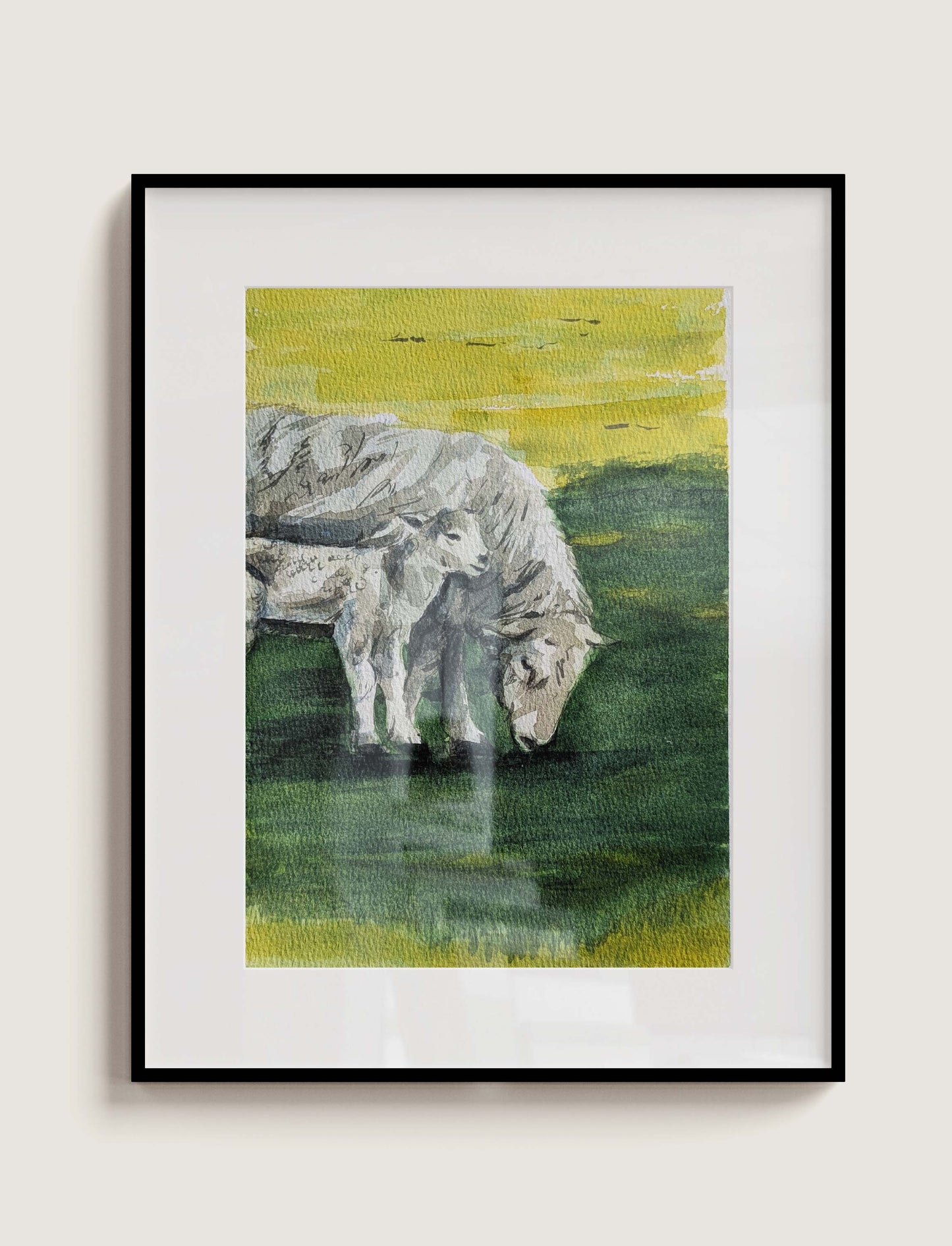 Framed watercolour painting of an ewe and its lamb grazing on a vivid yellow field at West Dean, by Daniela Militaru